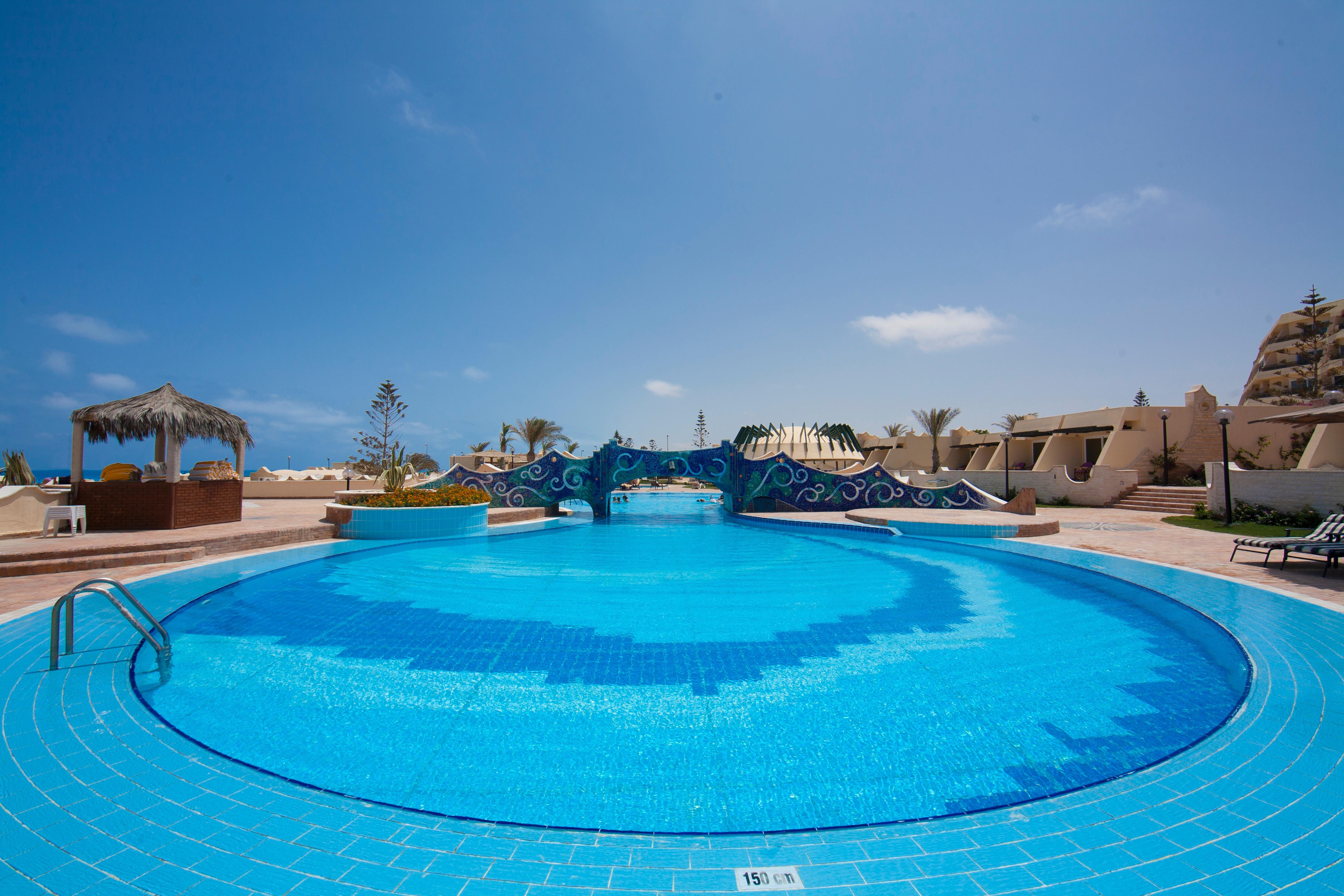 Borg El Arab Beach Resort Dış mekan fotoğraf A swimming pool at a resort in Egypt